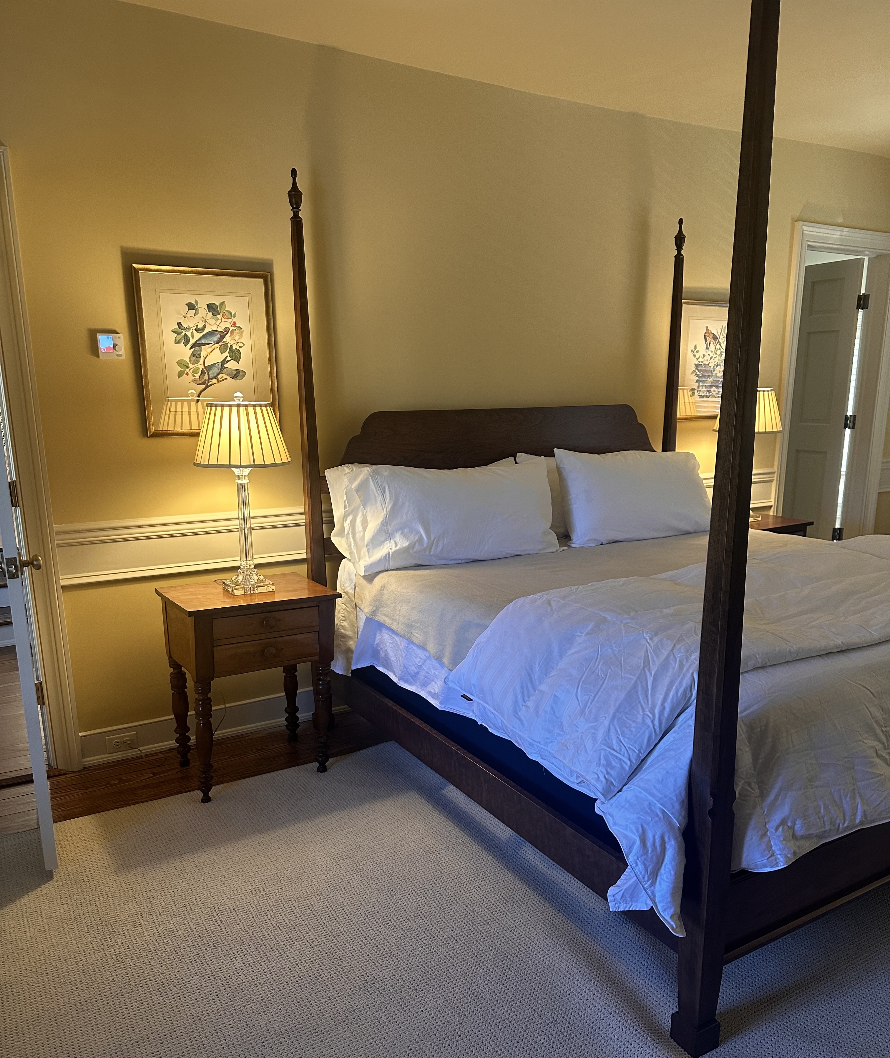 king-sized pencil post bed with two nightstands with lamps