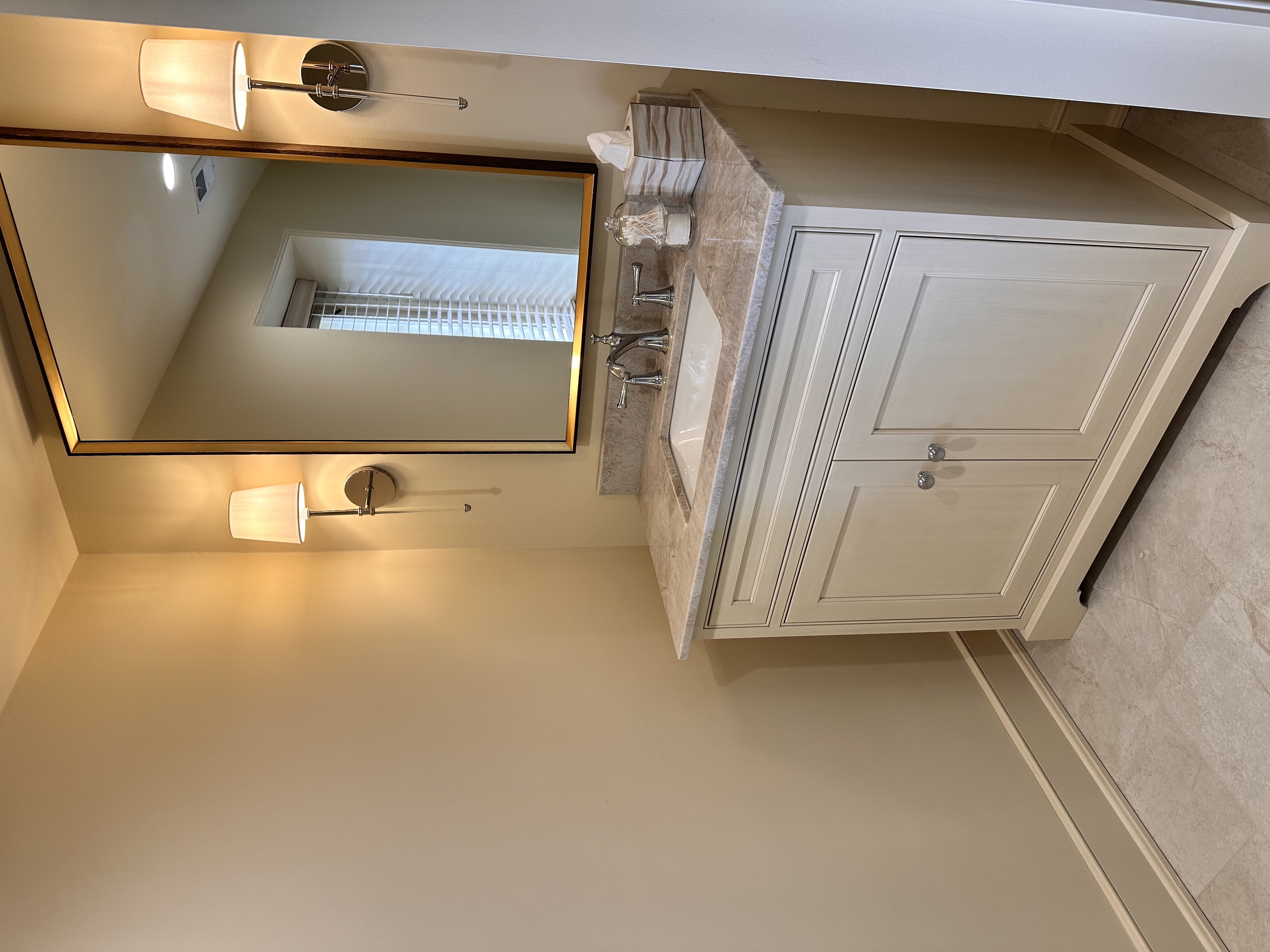 single vanity with sconces on either side of mirror