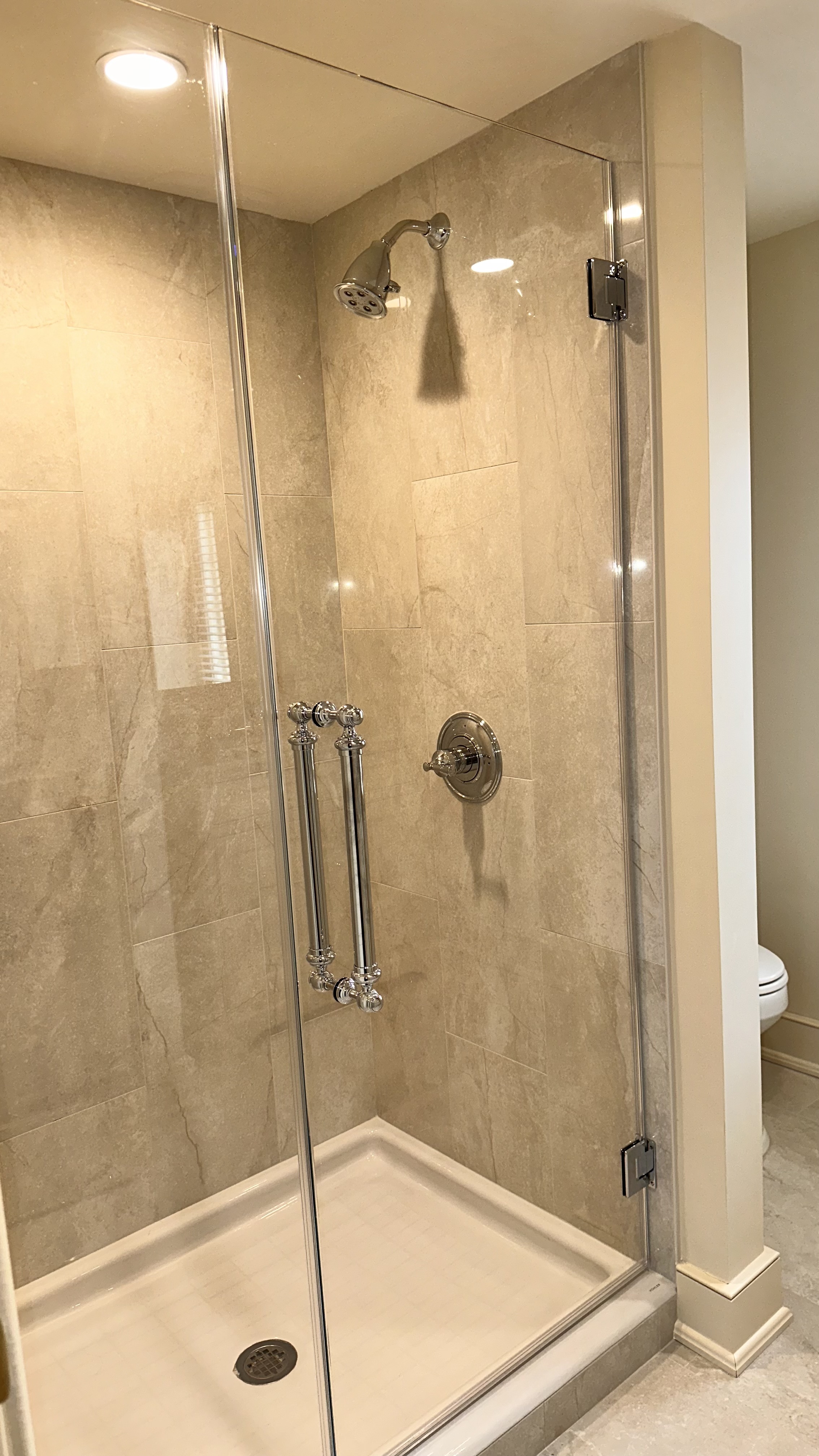 tiled shower with glass door