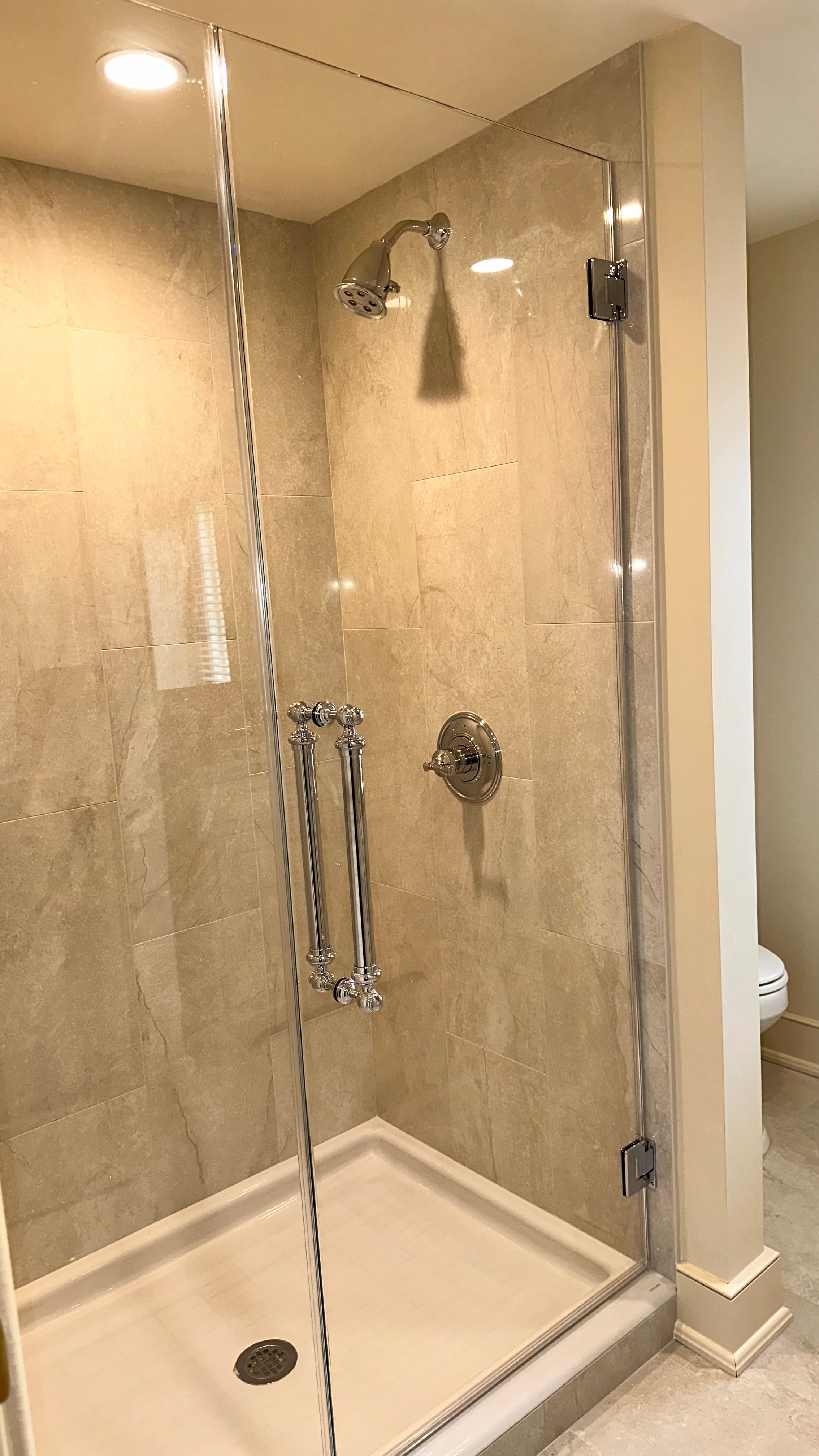 tiled shower with glass door
