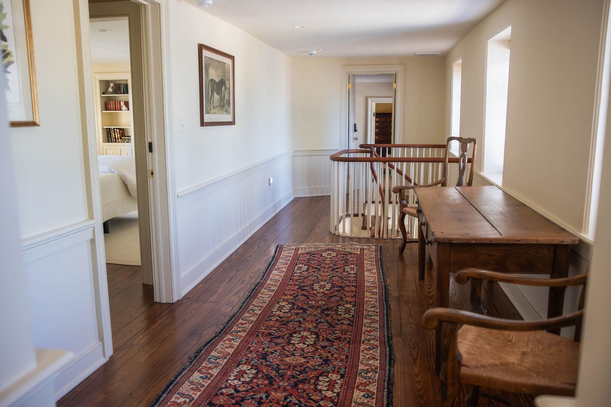 Entry door to Suite 2 and hallway with railing
