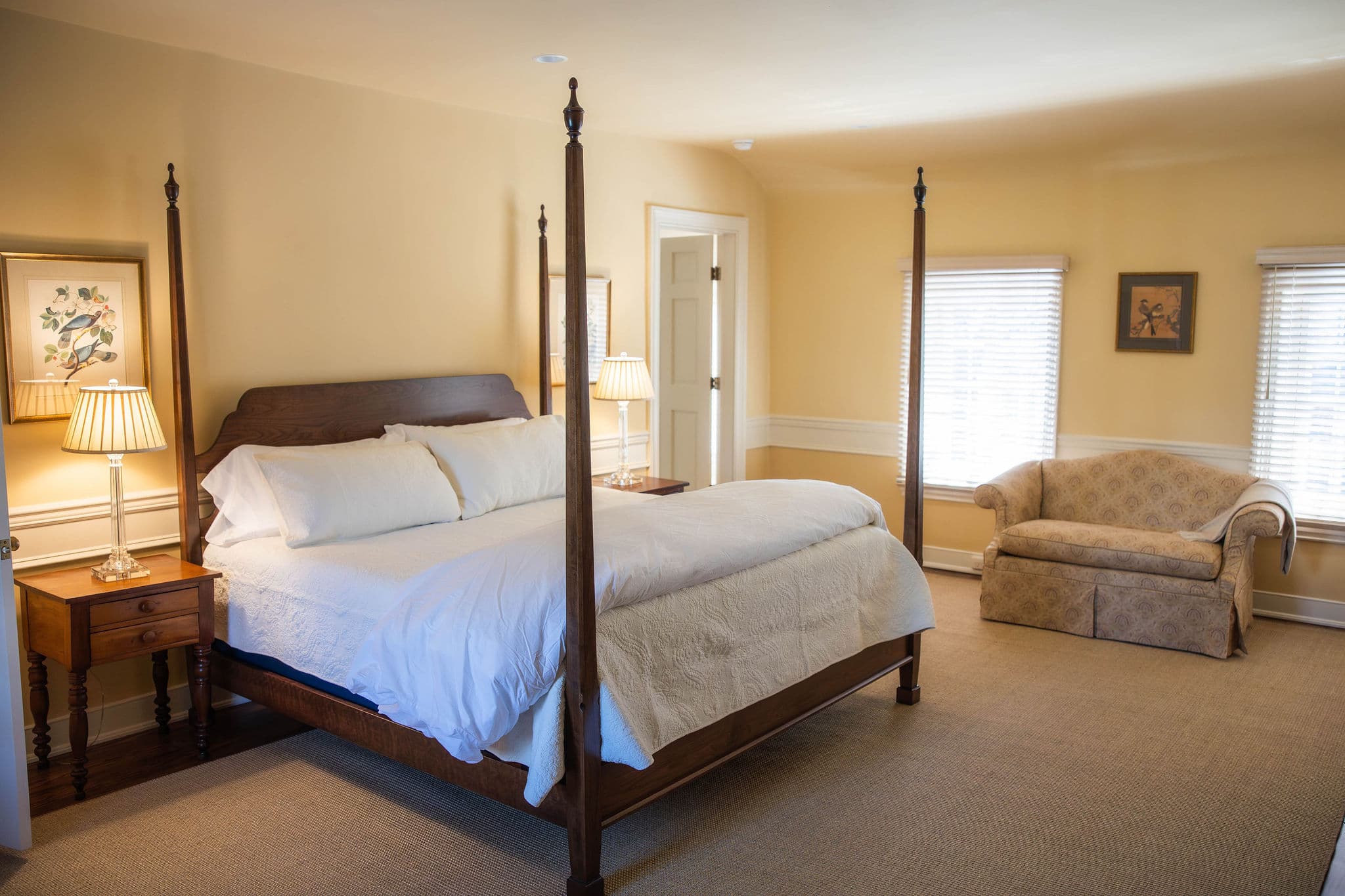 king-sized pencil post bed with two nightstands with lamps