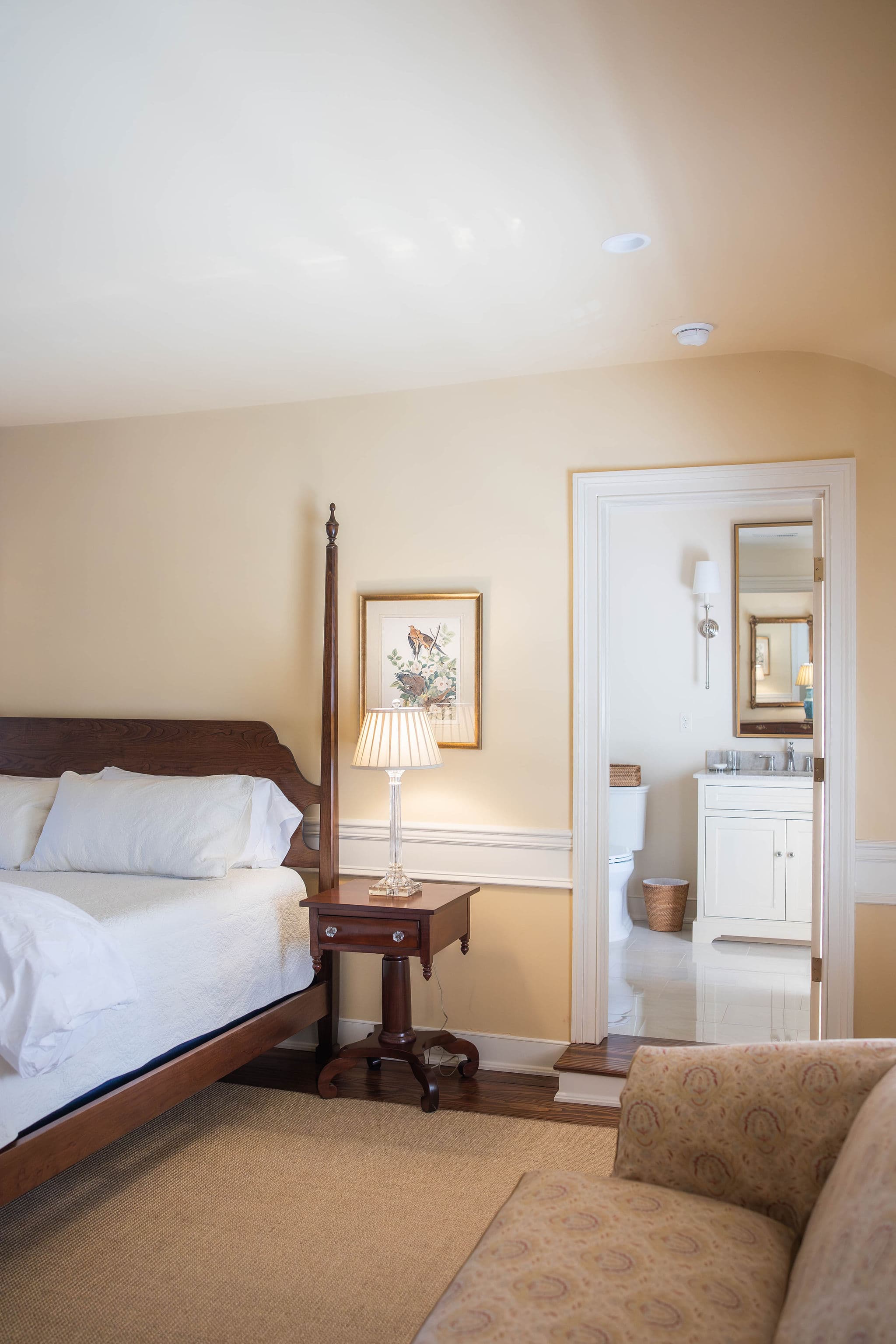 bed to the left and a step up into the bathroom area