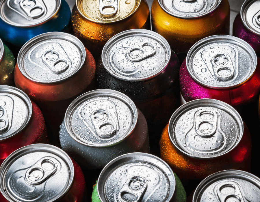 A close-up of colorful, wet soda cans with visible pull tabs.