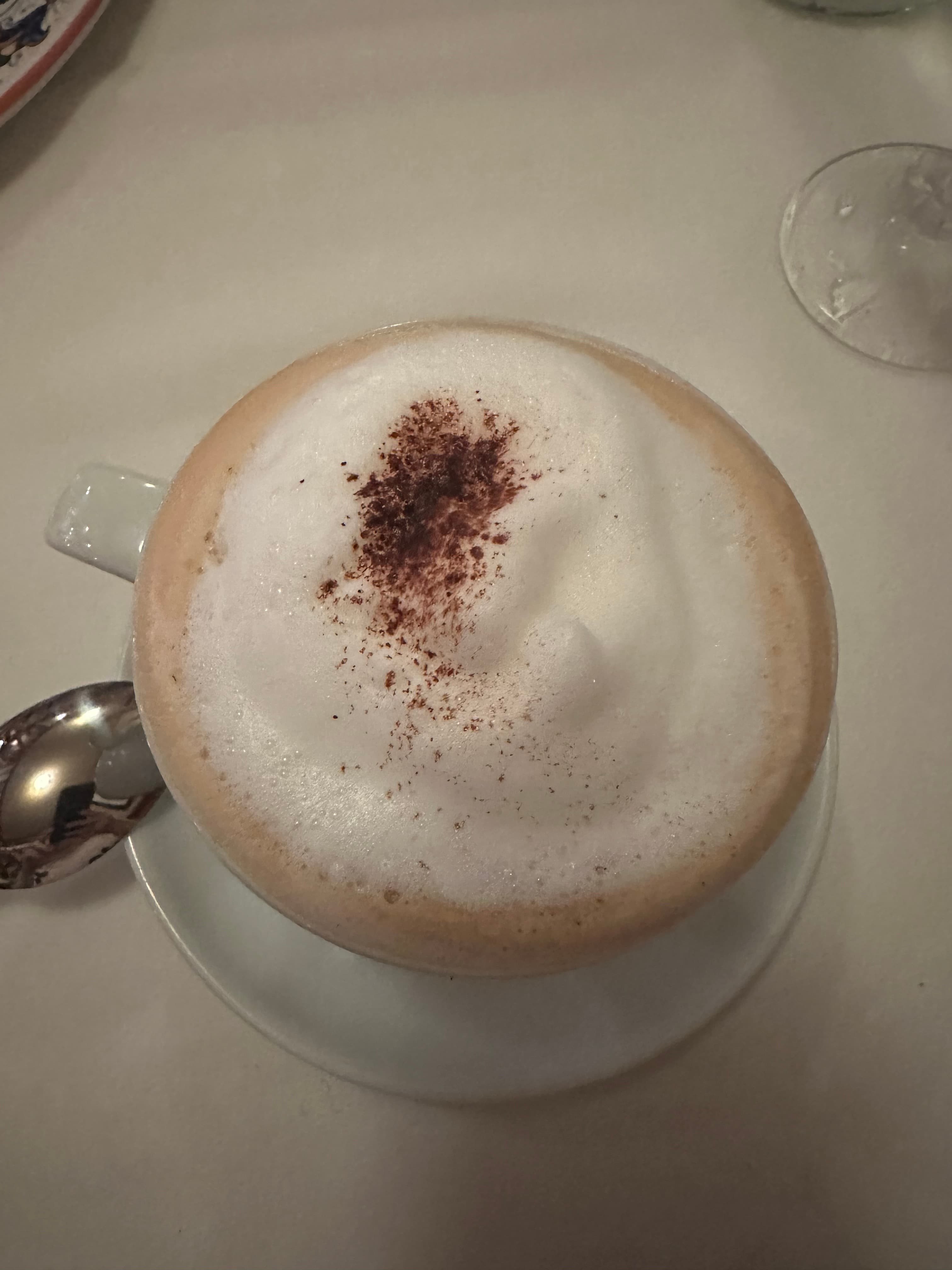 A cappuccino topped with cinnamon on frothy milk.