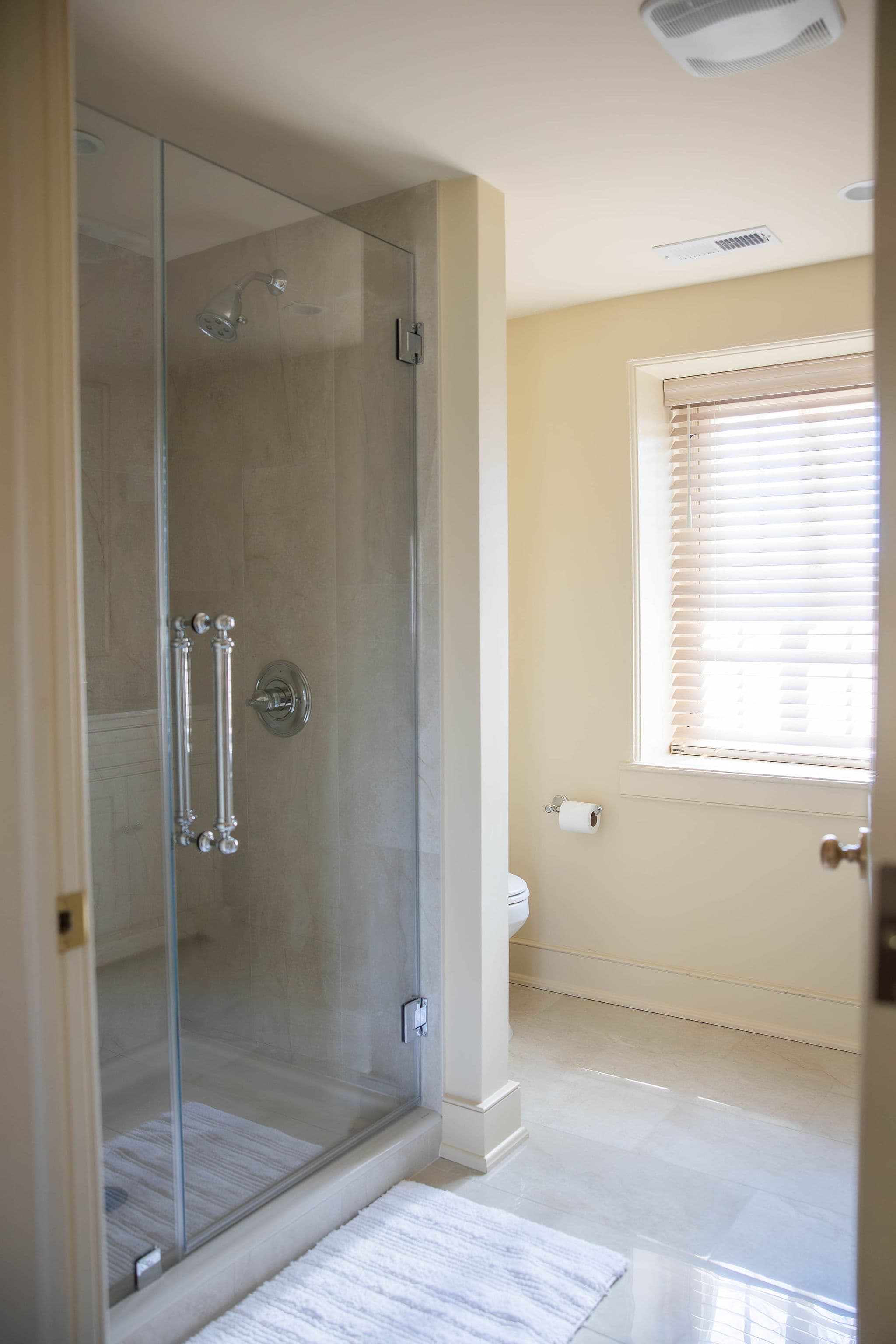 tiled shower with glass door